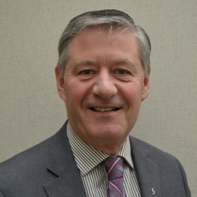 Portrait of a smiling middle-aged man in a suit with a striped tie.
